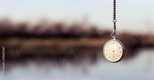 Pocket watch hanging from sky