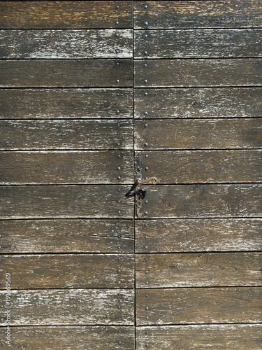 Full frame pattern of the planks of an unsual wooden door construction. Timber deteriorating due to breakdown of treatment coating. photo