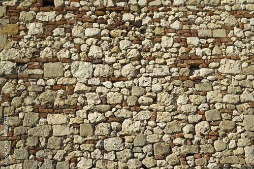 Full frame texture background of an old rubble stone and brick wall construction