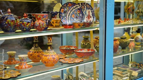Close up of the shop window with many colourful ceramic handmade dishes in the nice light. Outside photo