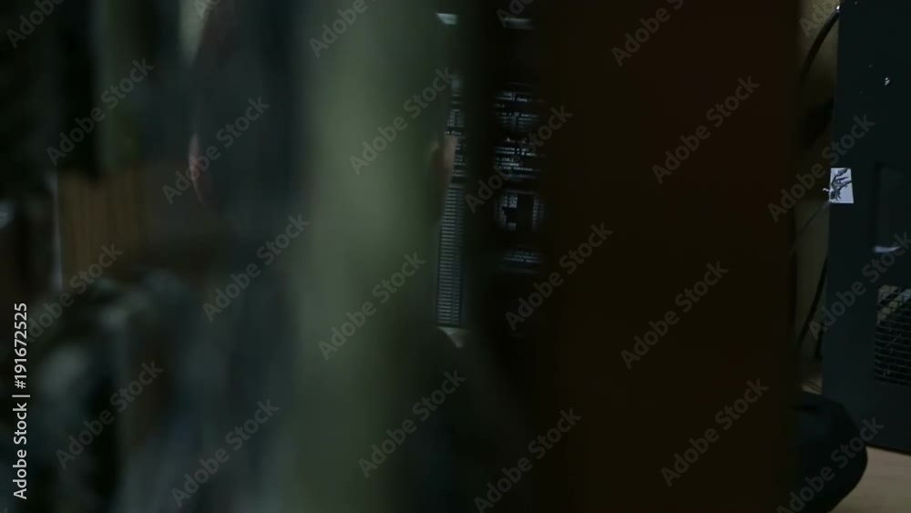 System administrator at work. Handheld shot in instrumentation laboratory. Server equipment. Filmlook scene. System administrator at work. Handheld shot in instrumentation laboratory. Server equipment. Filmlook scene.