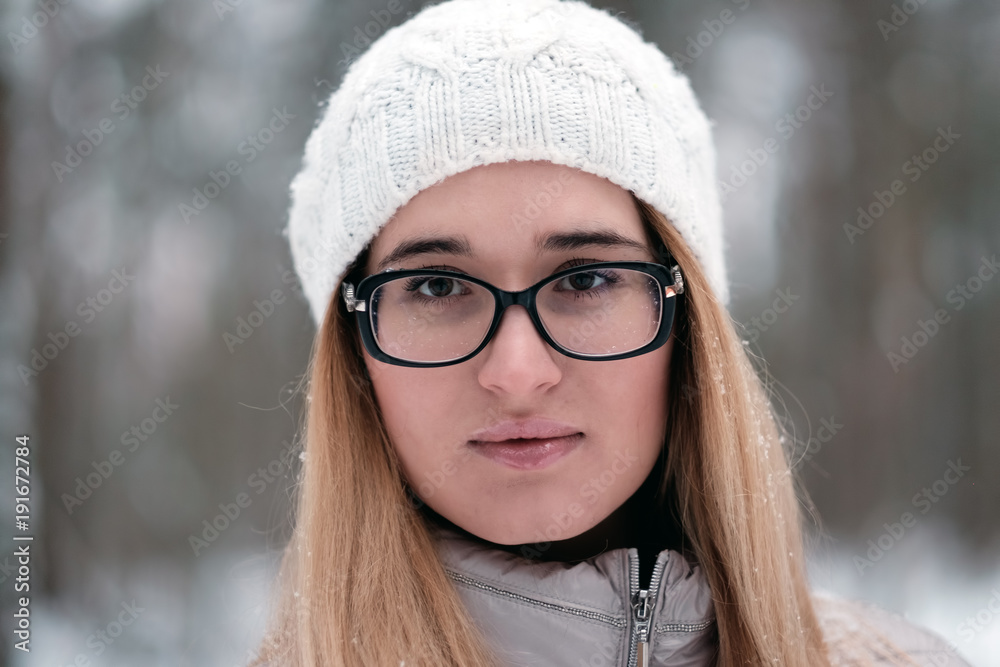 Portrait of a beautiful young woman on a winter forest background. Portrait of a beautiful young woman on a winter forest background.