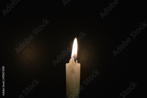 White candle on a black table