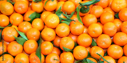 perfect background of ripe clementines for sale at the market