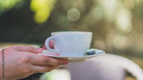Hands holding hot cup of coffee