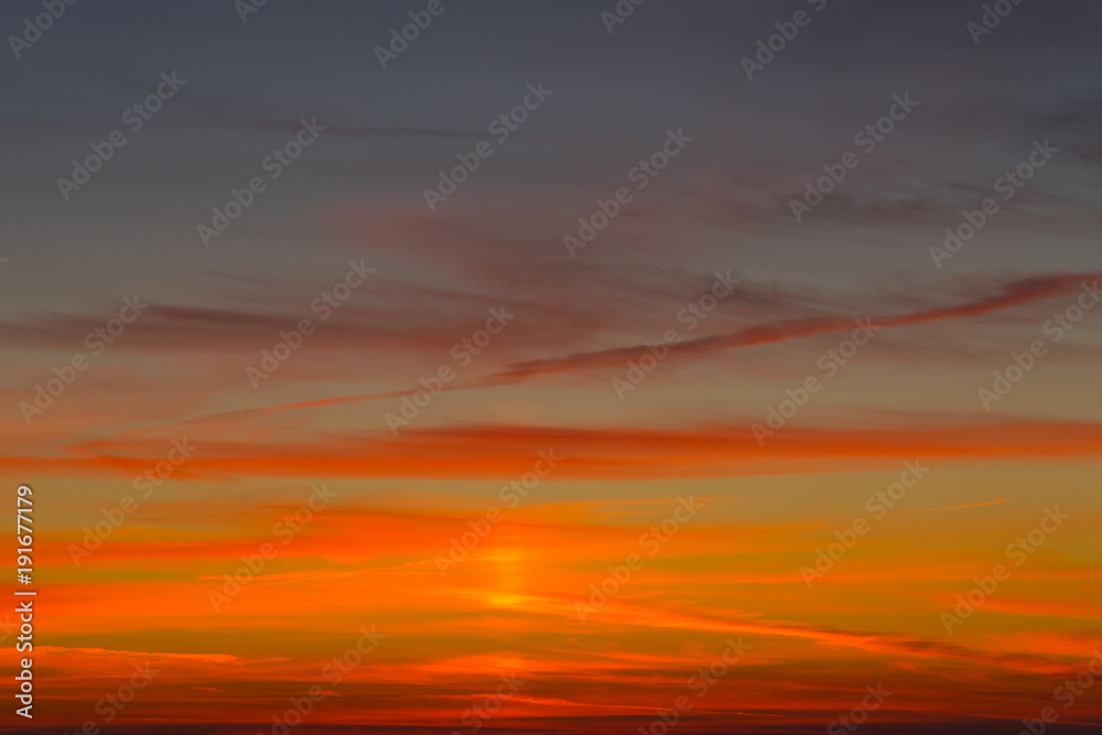 Bright orange-red sunset on a dark blue sky.
