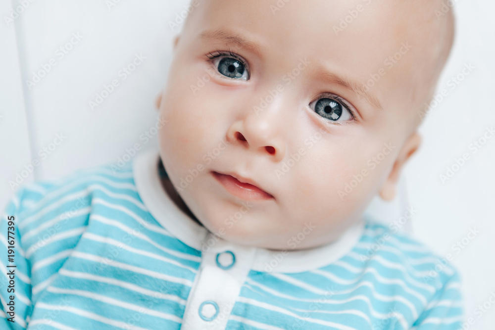 The kid looks beautiful eyes on a light background The kid looks beautiful eyes on a light background