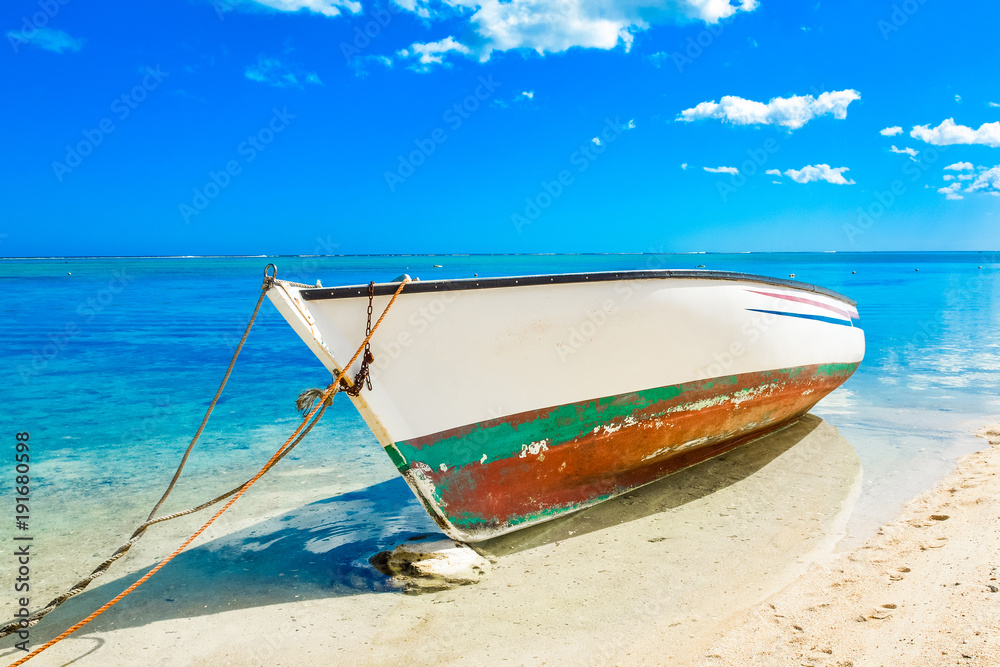 Old wooden boat on the shore of Indian ocean Old wooden boat on the shore of Indian ocean