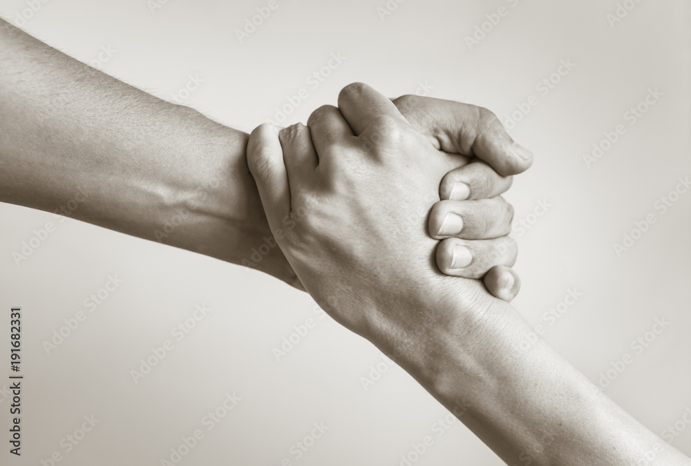 Two hands helping another. People helping each other. Stock Photo