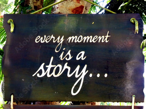 Inspirational motivation quote Every moment is a story on a sigh hanging in tree