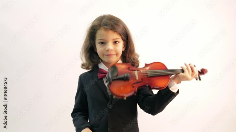 A young handsome musician plays the violin. White background. A young handsome musician plays the violin. White background.