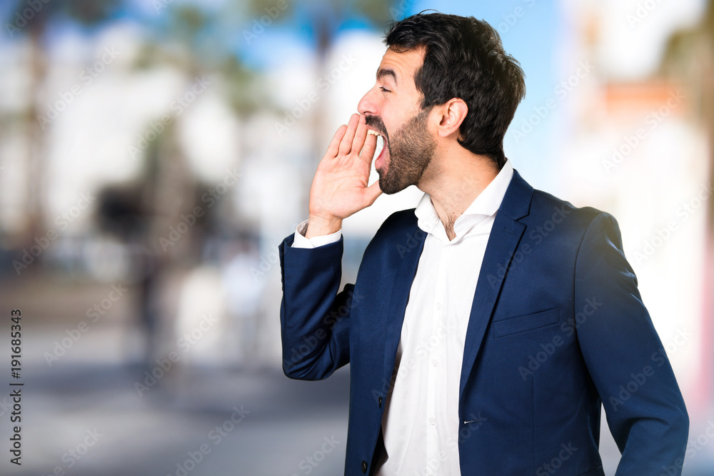 Handsome man shouting on unfocused background Handsome man shouting on unfocused background