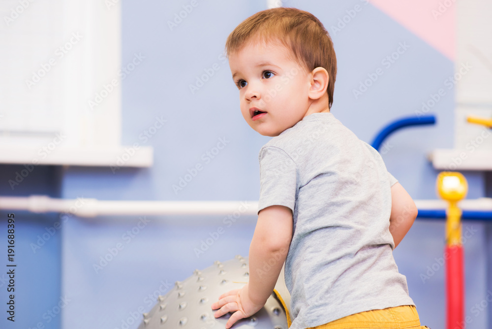 little baby plays with a fitball in the gym little baby plays with a fitball in the gym