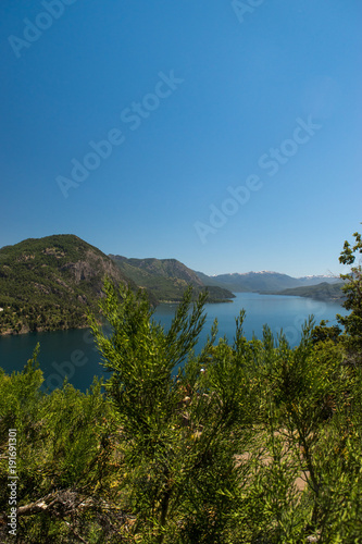 Portrait taken from the height with view overlooking the blue lake surrounded by mountains