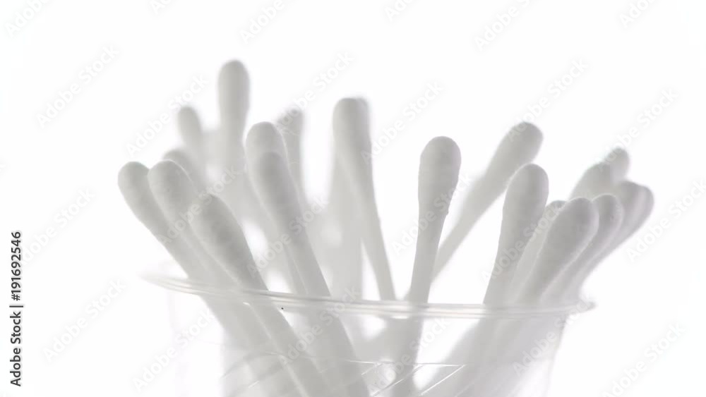Cotton buds. White cotton buds closeup rotated on white background. 4K UHD video footage. 3840X2160 Cotton buds. White cotton buds closeup rotated on white background. 4K UHD video footage. 3840X2160