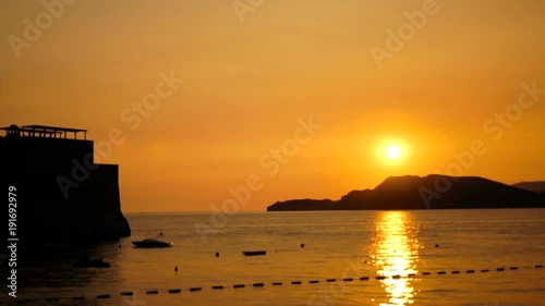 Beautiful amazing sunset over the sea surrounded by mountains and cliffs. Outdoor photo