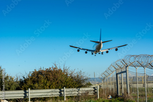 Horizontal View of a Cargo Airplane in the Landing Operation in The Morning. Grottaglie, Taranto, South of Italy