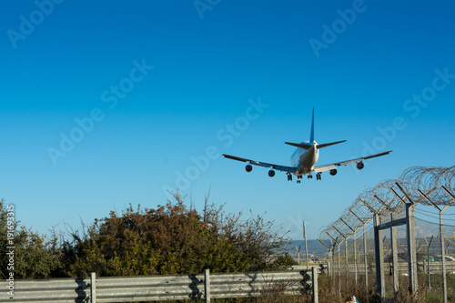 Horizontal View of a Cargo Airplane in the Landing Operation in The Morning. Grottaglie, Taranto, South of Italy