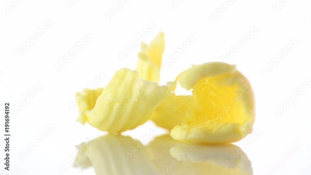 Butter. Curls of fresh natural butter rotated on a white background. 4K UHD video footage. 3840X2160 Butter. Curls of fresh natural butter rotated on a white background. 4K UHD video footage. 3840X2160