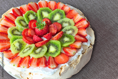 Pavlova meringue cake with strawberries and kiwi photo