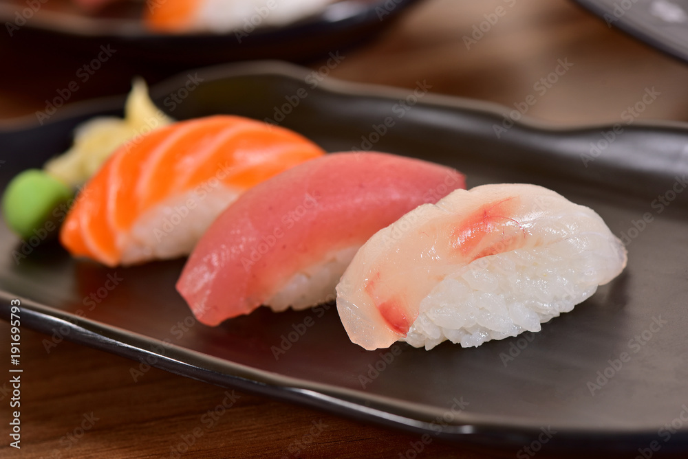 Salmon and Tuna Nigiri Sushis on restaurant table Salmon and Tuna Nigiri Sushis on restaurant table