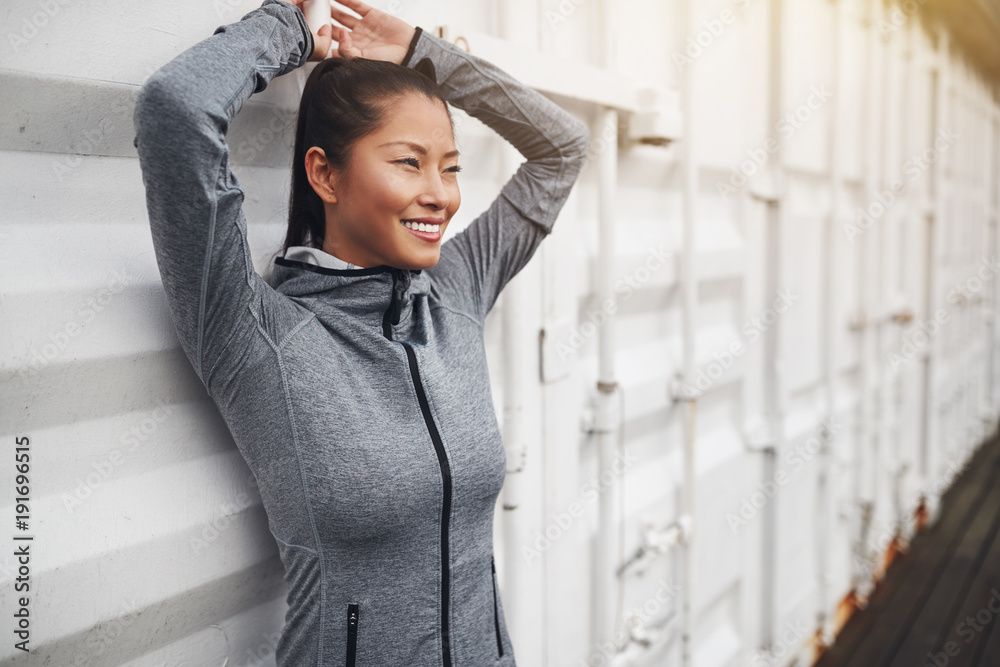Smiling Asian woman in sportswear standing outside before a jog Smiling Asian woman in sportswear standing outside before a jog