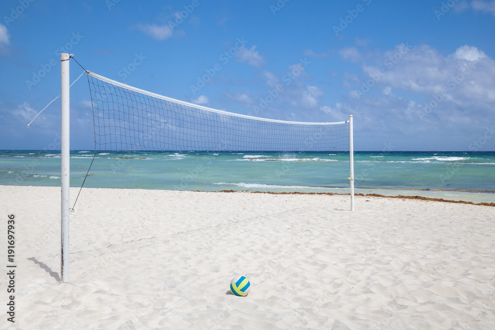 Volleyball net and ball on the tropical beach Volleyball net and ball on the tropical beach