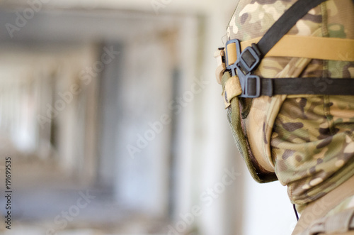 Fototapeta Naklejka Na Ścianę i Meble -  Soldier head close up protection head mask and goggles hand up mask helmet 