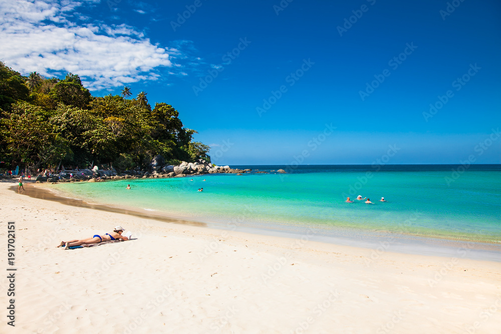 Unidentified people are relaxing on Kata beach in Phuket, Thailand.