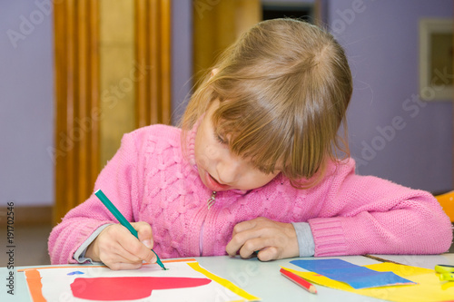 Child draw a postcard. Children are engaged in needlework. The girl signs a postcard on 14 February.