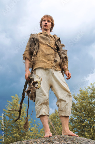 young medieval peasant with a wooden staff