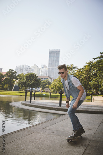 Young people use skatboard for relaxing time together outdoor at the city in the park