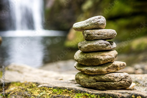 rock cairn with waterfall