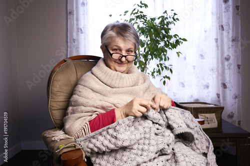 Close-up Portrait of Senior Woman Knitting with Wool, Grandmothers Hands Knit Wool Yarn. Craft is Hobby of Old Women. Senior Lady, Happy Granny Knitted Sweater Handmade. 