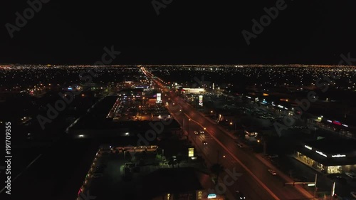 Aerial establishing shot of a vast city with lights at night