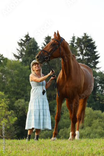 Portrait of woman and her chestnut horse