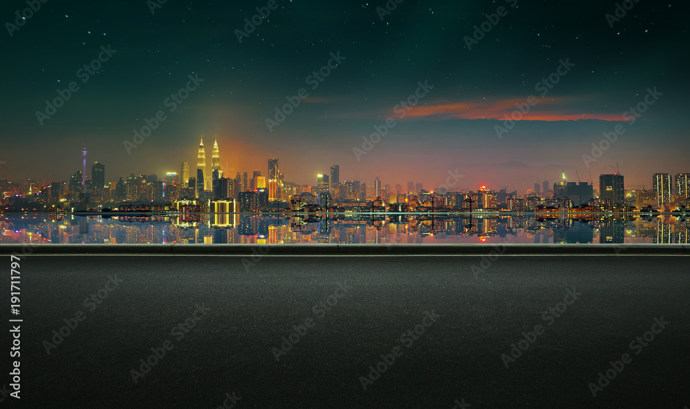 Obraz premium Panoramic view of asphalt road side with beautiful Kuala Lumpur city waterfront skyline. Night scene .
