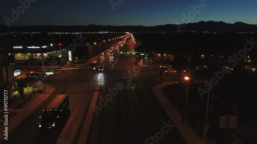 Aerial establishing shot of large city with lights at night dolly