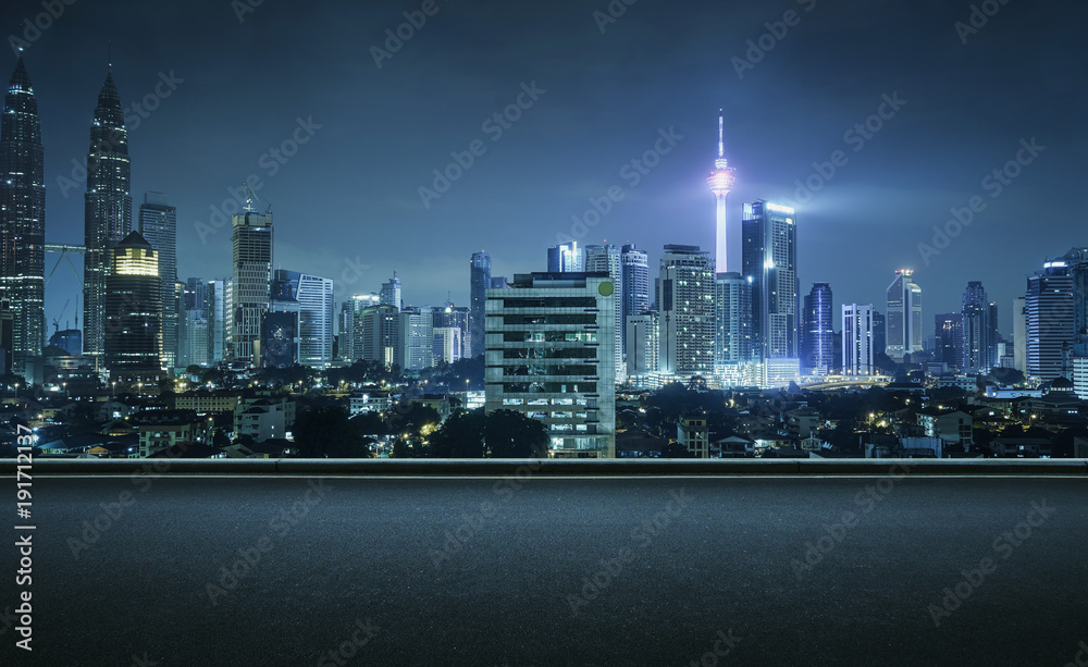 Naklejka premium Asphalt road side with beautiful Kuala Lumpur city skyline. Night scene .