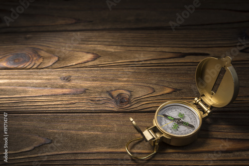 Vintage gold compass on tree background. copy space. Place for text and advertising. Idea: travel, tourism, navigation