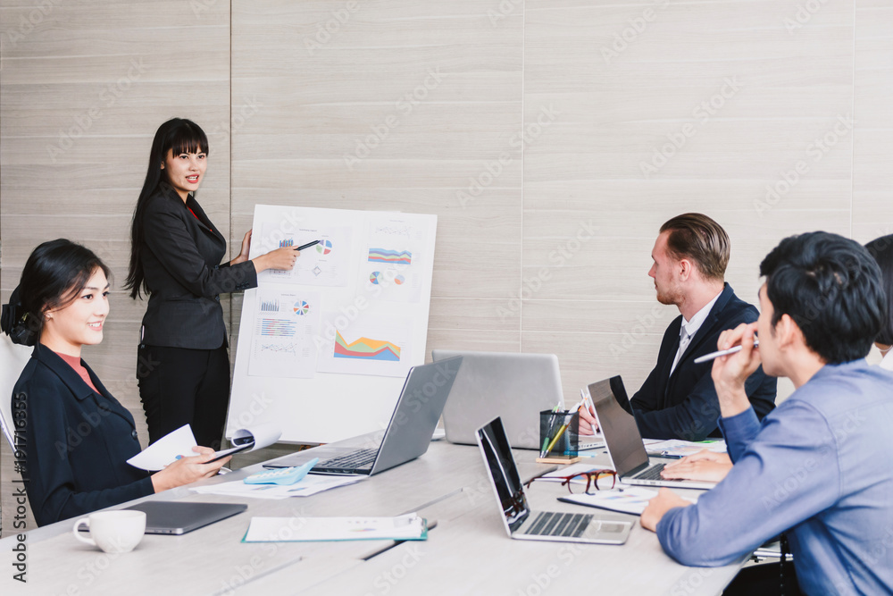 Businesspeople presenting and using laptops and discussing together in meeting room.Teamwork concept Businesspeople presenting and using laptops and discussing together in meeting room.Teamwork concept