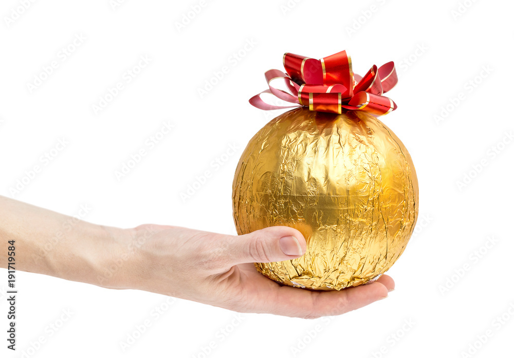 Hands hold round golden gift with bow. Isolated on white. Hands hold round golden gift with bow. Isolated on white.