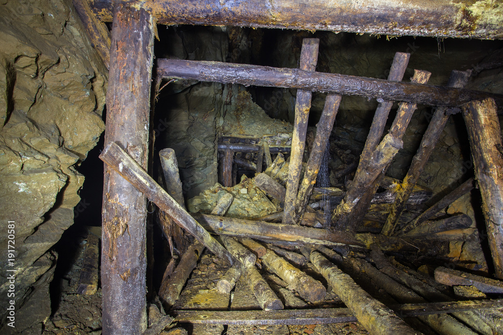 Underground abandoned gold ore mine shaft tunnel gallery collapsed wooden timbering