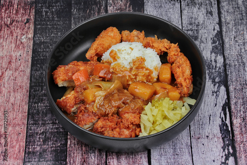 Rice with deep fried chicken,sliced picklesl topped Japanese yellow curry .