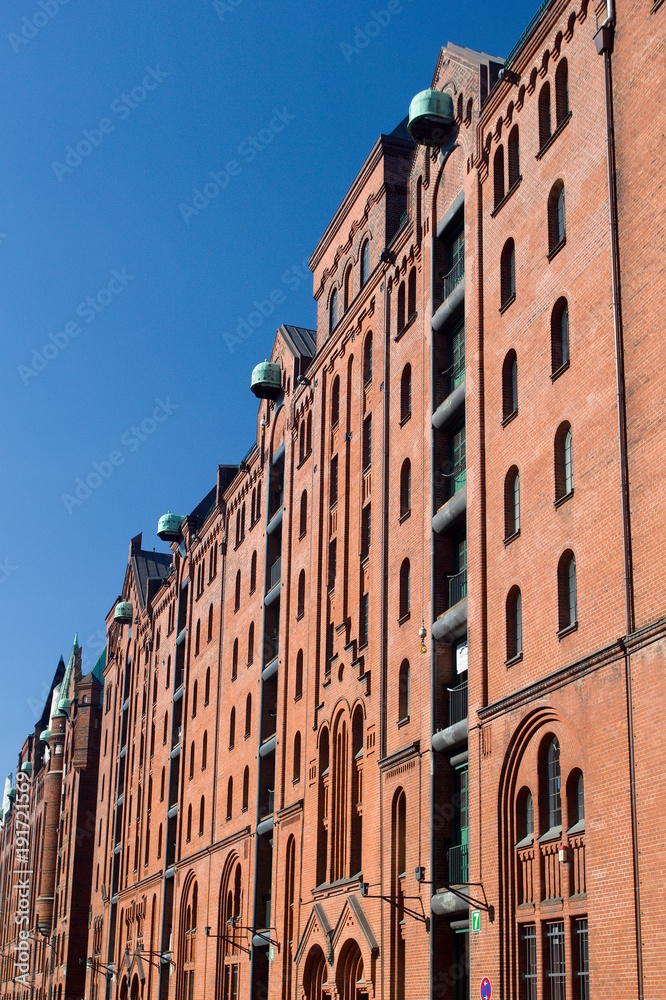 Red brick facade of warehouse buildings in Speicherstadt - the largest historic warehouse district in the world, located in the HafenCity quarter, Hamburg, Germany.
