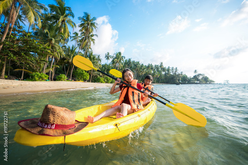 Asian kid to play Kayak on the beach on Koh Kood