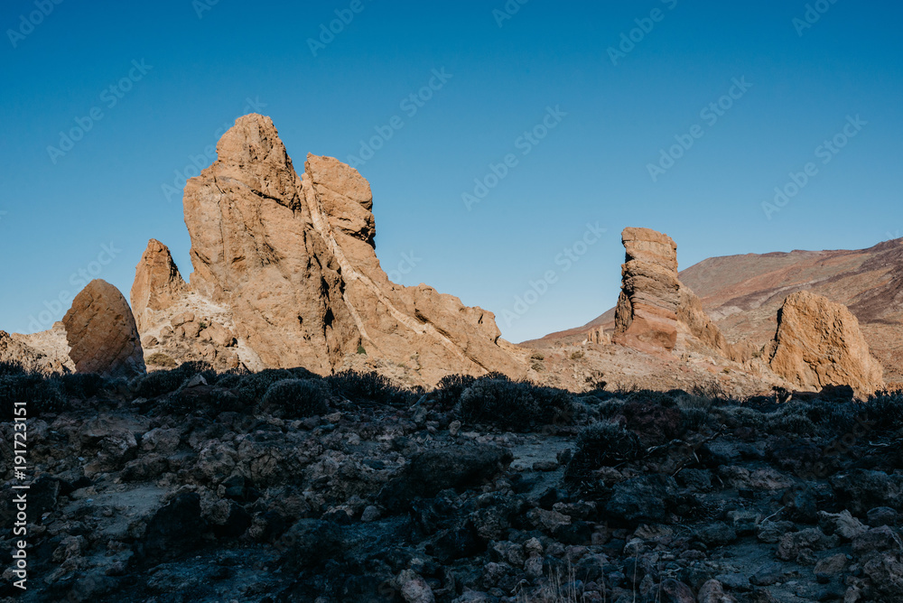 Beautiful rocks with blue sky and a huge shadow on the front in the morning