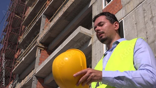 Engineer foreman builder removing helmet hardhat cooling down exhausting work 4K