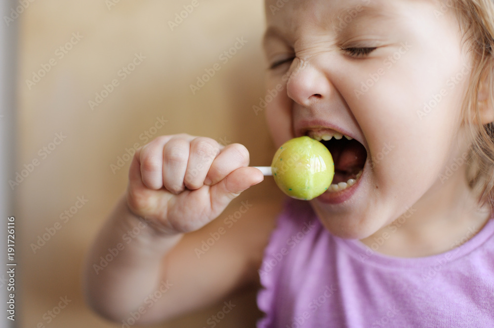 The girl eats big lollipop. The girl licks candy The girl eats big lollipop. The girl licks candy
