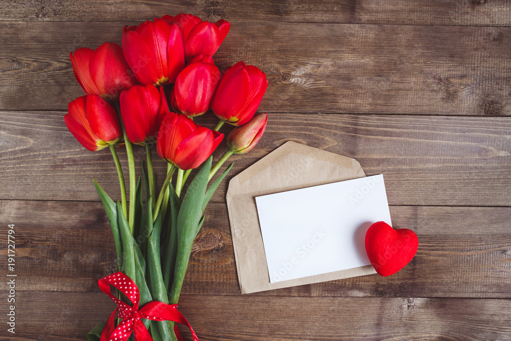 Spring flowers. Bouquet of Red tulips on brown wooden background. Spring flowers. Bouquet of Red tulips on brown wooden background.